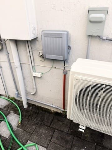 Mini-split condenser installed by AirWise outside a Miami-Dade home